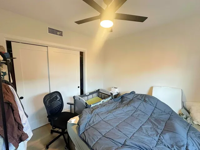 a fan sitting in a room next to a window