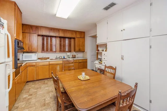a room with wooden furniture and a mirror