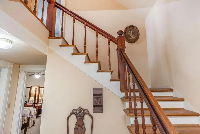 a bedroom with bed and wooden floor
