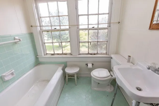 a bathroom with a tub and a shower