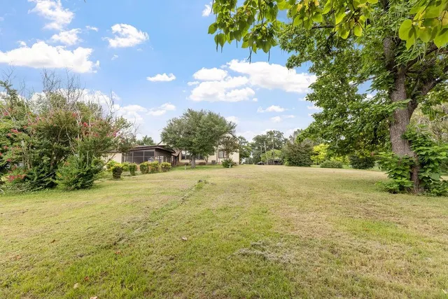 a view of a house with backyard porch and garden