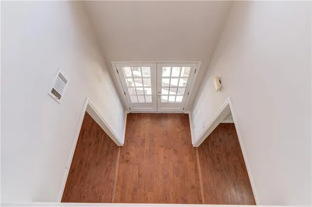 an empty room with closet and a chandelier fan