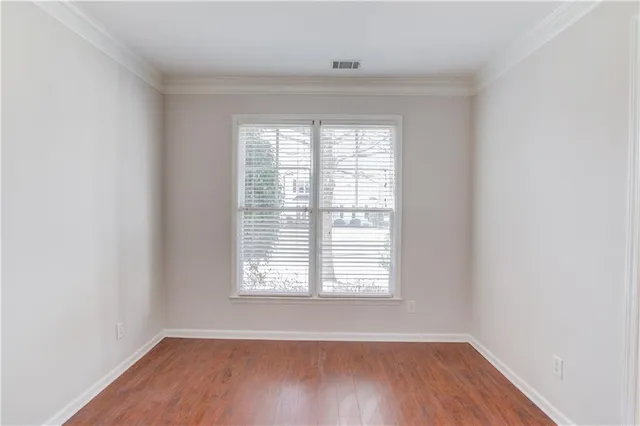 a view of empty room with window and ceiling fan
