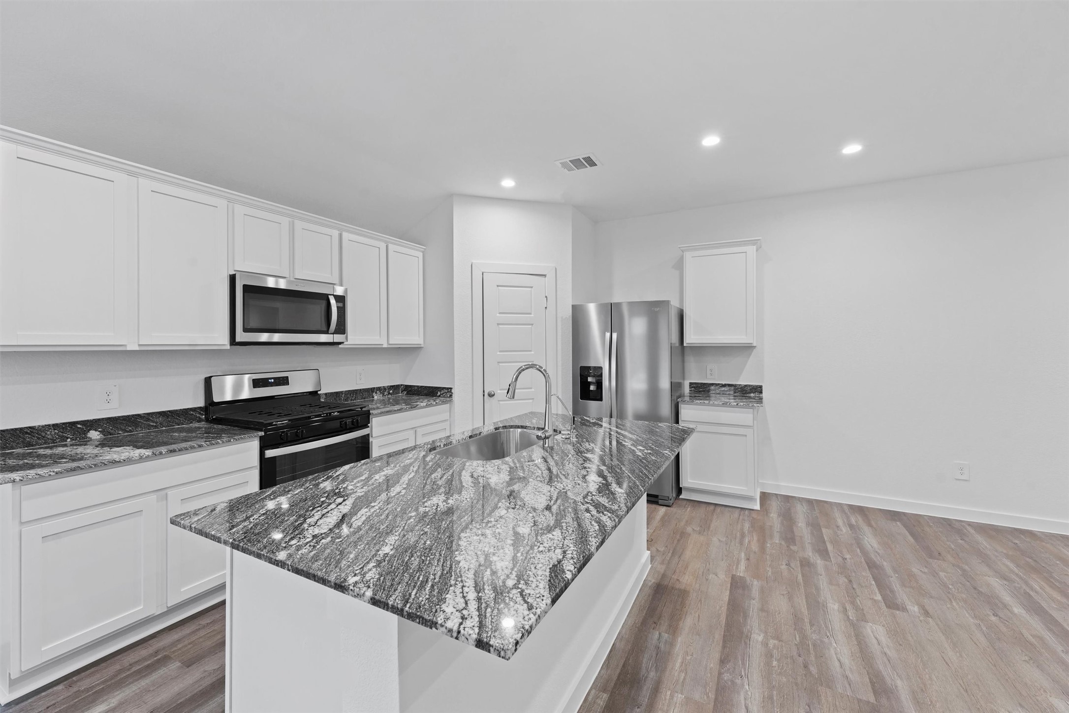1115 Briscoe Court Rosharon, TX 77583 - Photo 6 of 16 a large kitchen with cabinets table and chairs