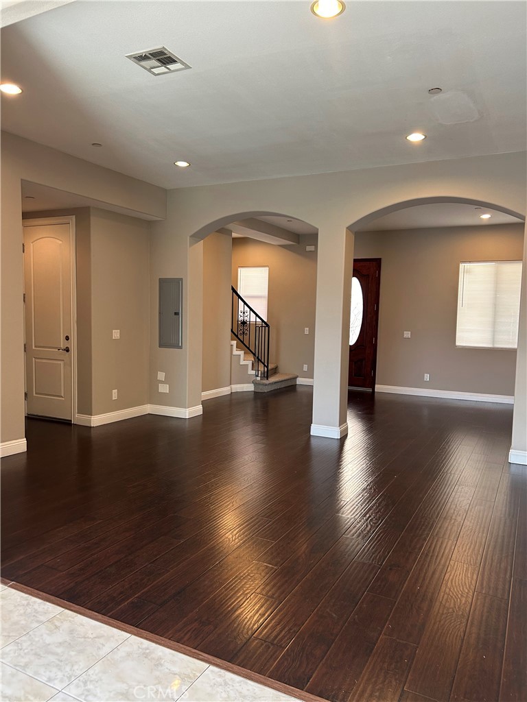 708 West Duarte Road, Unit C Monrovia, CA 91016 - Photo 3 of 12 an empty room with wooden floor and windows