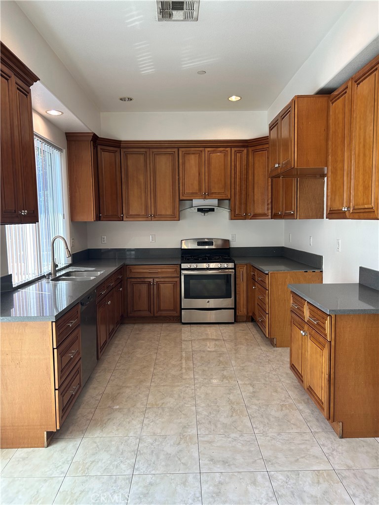 708 West Duarte Road, Unit C Monrovia, CA 91016 - Photo 4 of 12 a kitchen with stainless steel appliances granite countertop a stove sink and cabinets