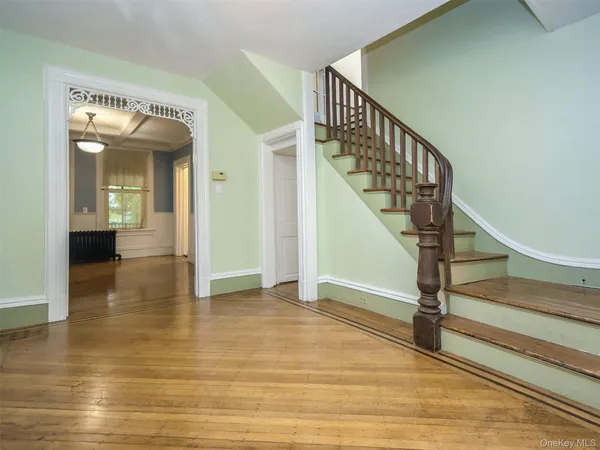 a view of entryway and hall with wooden floor