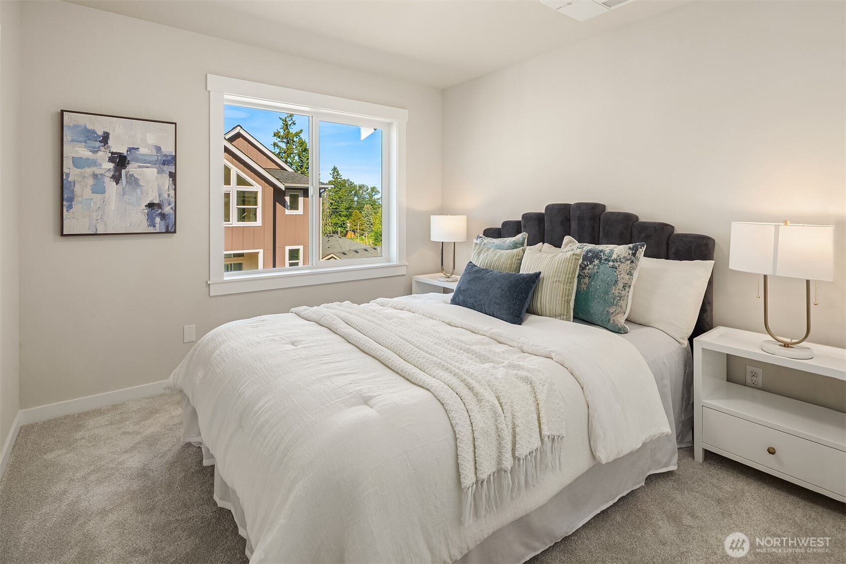 19722 Filbert Drive, Unit B3 Bothell, WA 98012 - Photo 31 of 39 a bedroom with a bed and a painting on the wall