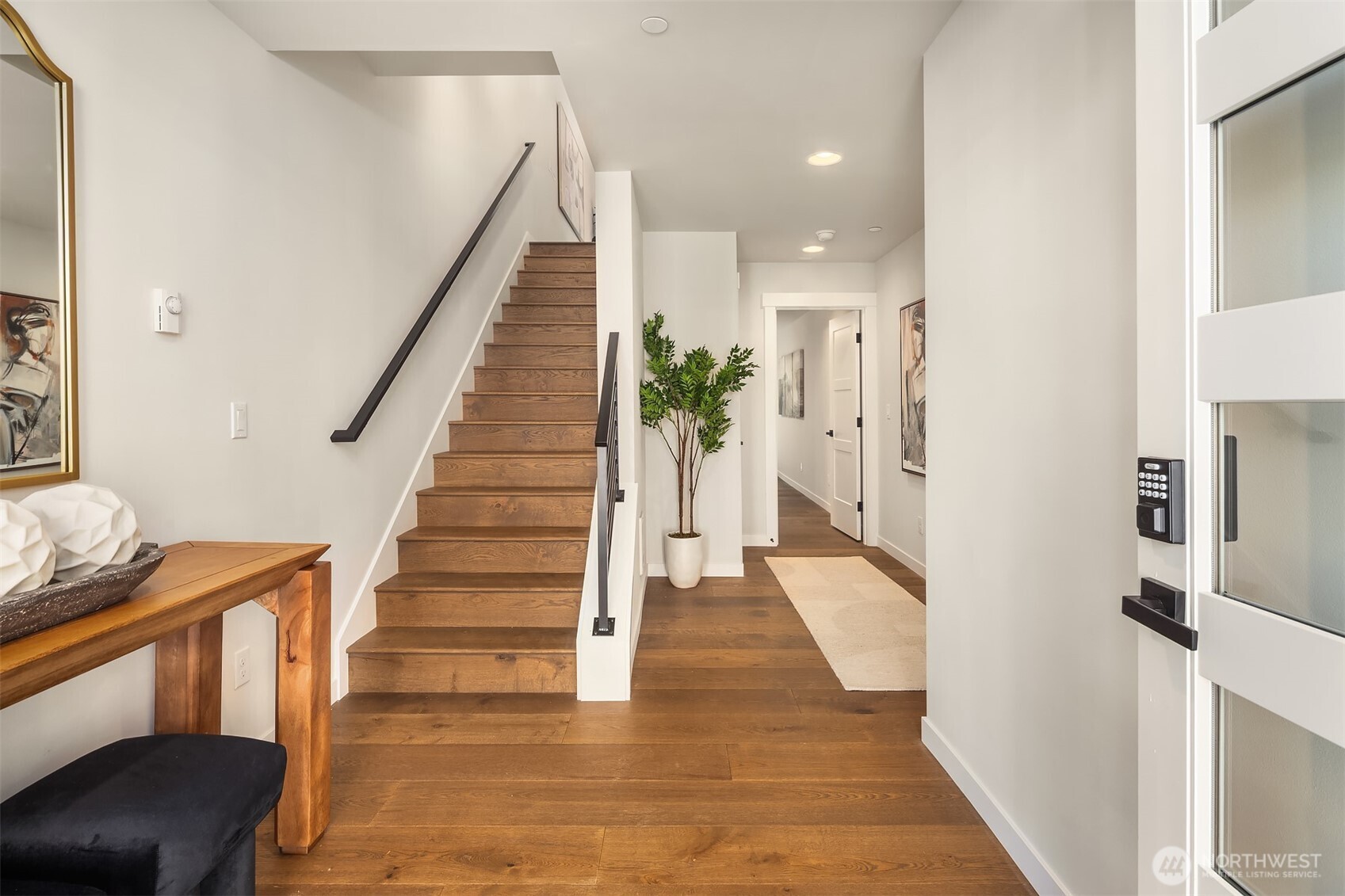 19722 Filbert Drive, Unit B3 Bothell, WA 98012 - Photo 4 of 39 a view of a hallway with wooden floor and staircase
