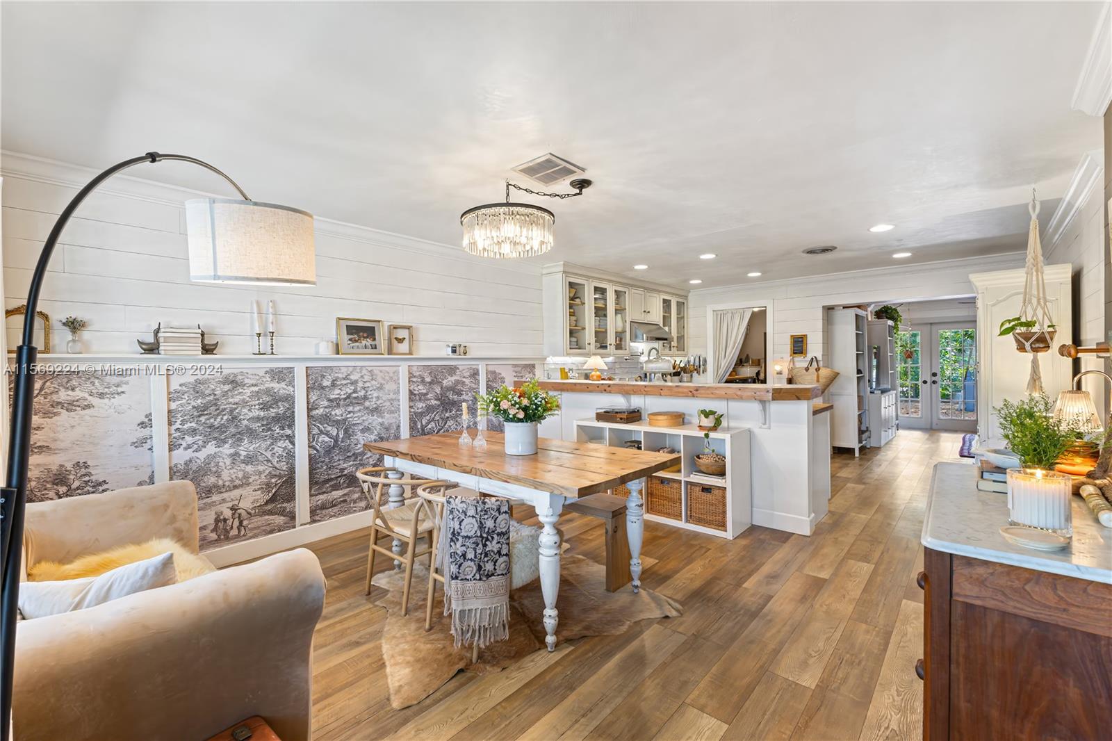 a kitchen with stainless steel appliances kitchen island granite countertop a stove a sink a dining table and chairs