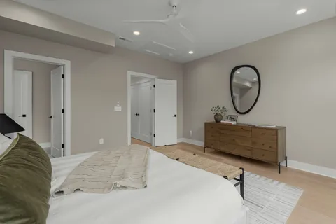 a bedroom with bed and a chandelier