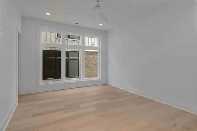 a view of an empty room with a kitchen