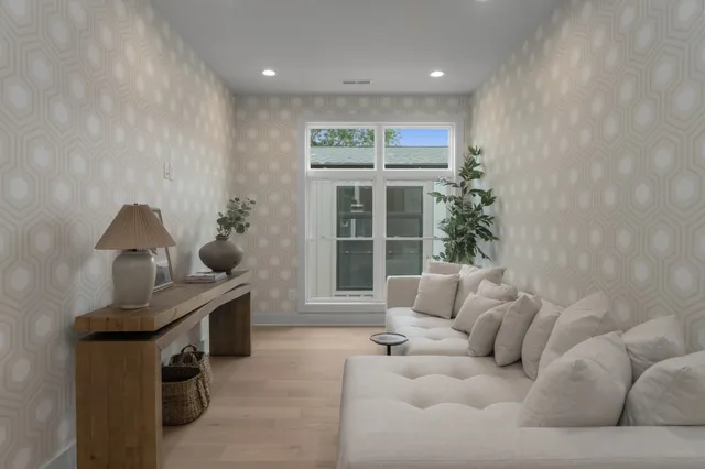 a living room with furniture and a potted plant