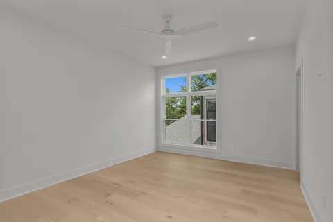 an empty room with windows and closet