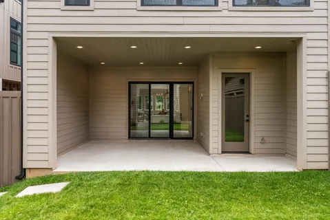 a view of a house with backyard and porch
