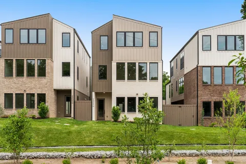 a view of a big house with a yard in front of it