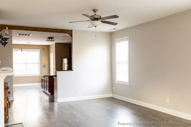 wooden floor in an empty room with a window