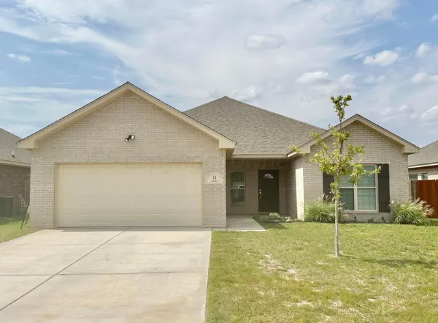 a view of a house with a backyard and a garden