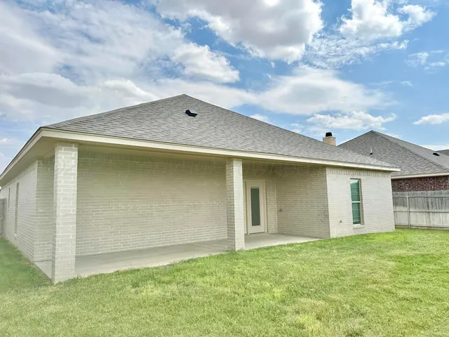 a view of house with backyard