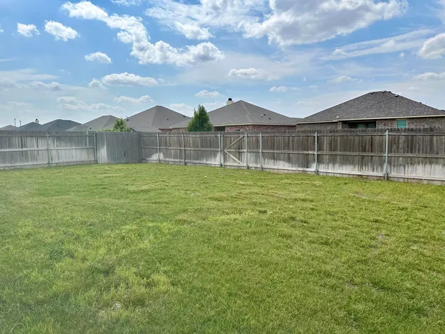 a view of a house with a yard and entertaining space