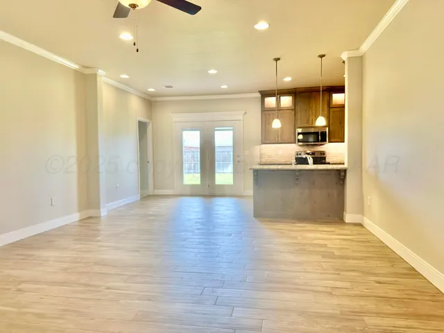 a view of a kitchen and a window in a room