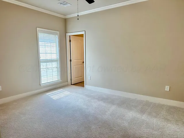 an empty room with windows and closet