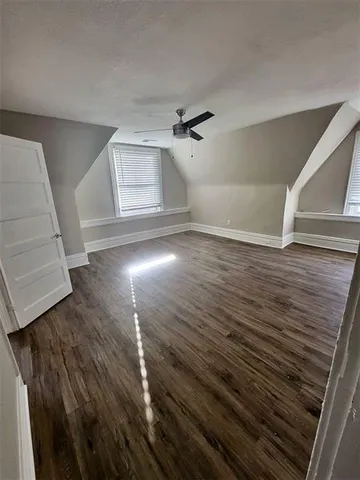 a view of a livingroom with wooden floor and stairs