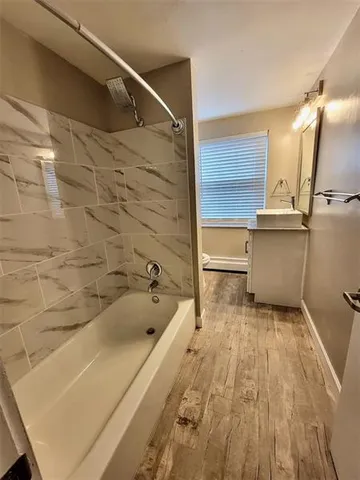 a bathroom with a bathtub and a sink