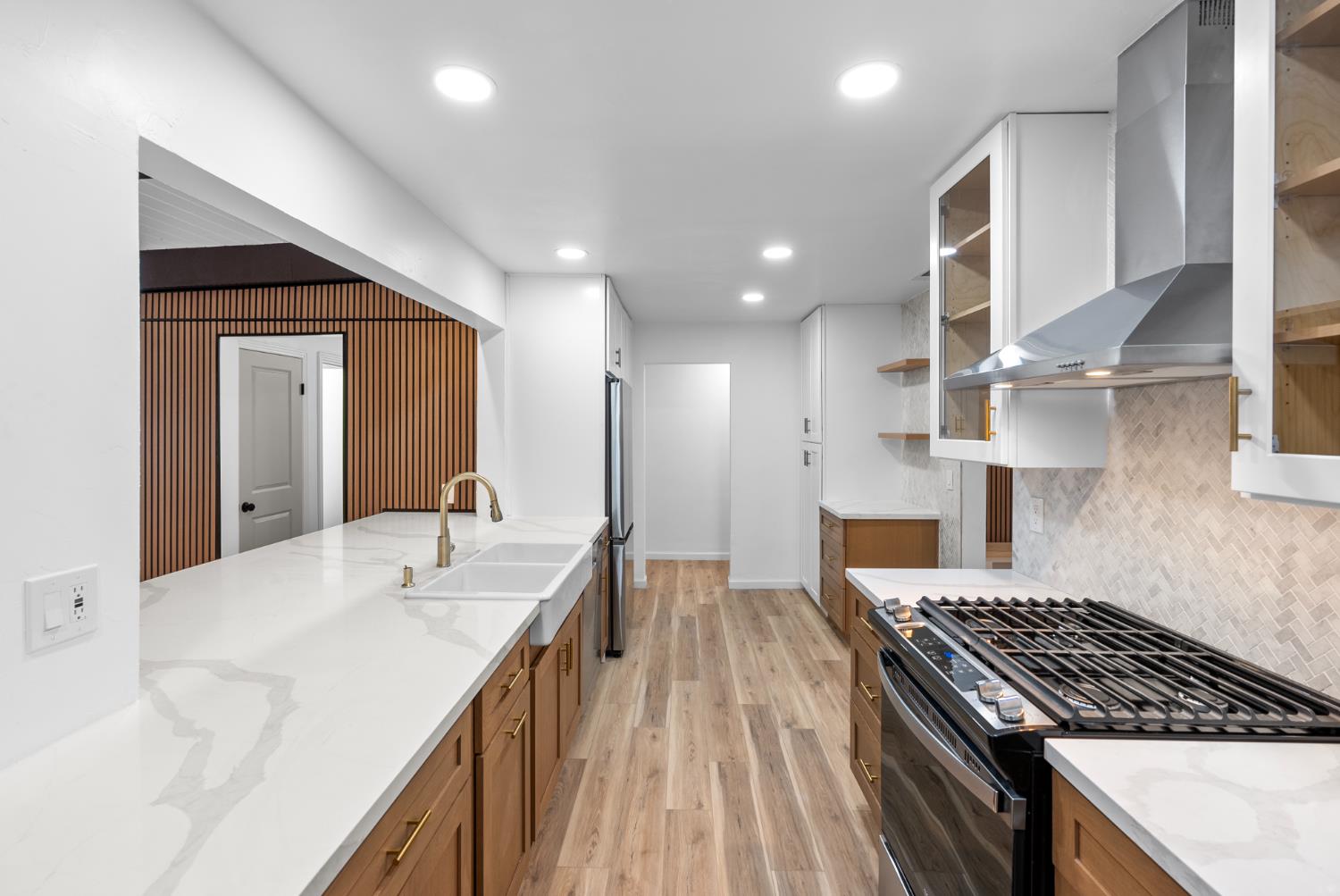 1125 Wellesley Avenue Modesto, CA 95350 - Photo 12 of 43 a kitchen with kitchen island a sink stove and cabinets