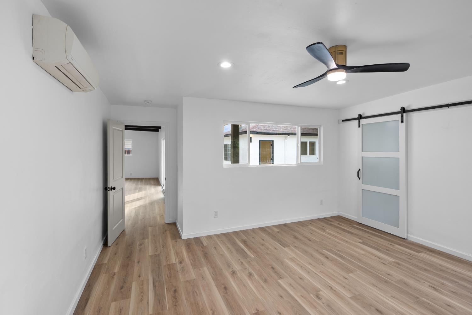 1125 Wellesley Avenue Modesto, CA 95350 - Photo 15 of 43 a view of empty room with wooden floor and fan