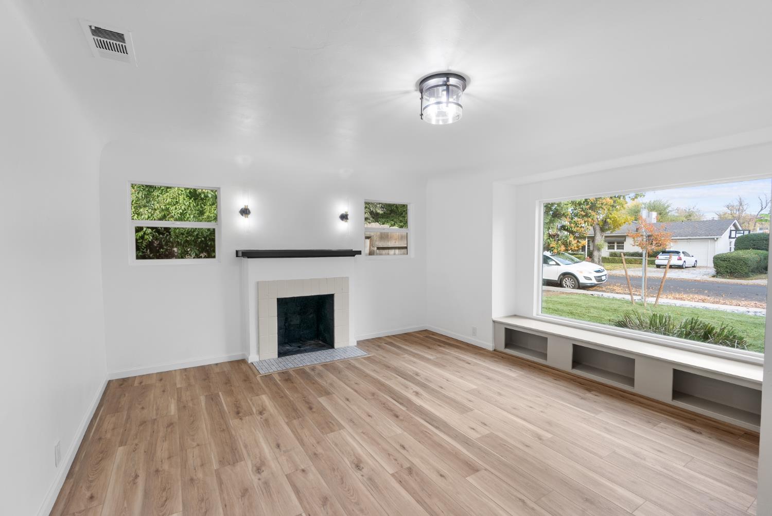 1125 Wellesley Avenue Modesto, CA 95350 - Photo 25 of 43 wooden floor fireplace and windows in an empty room