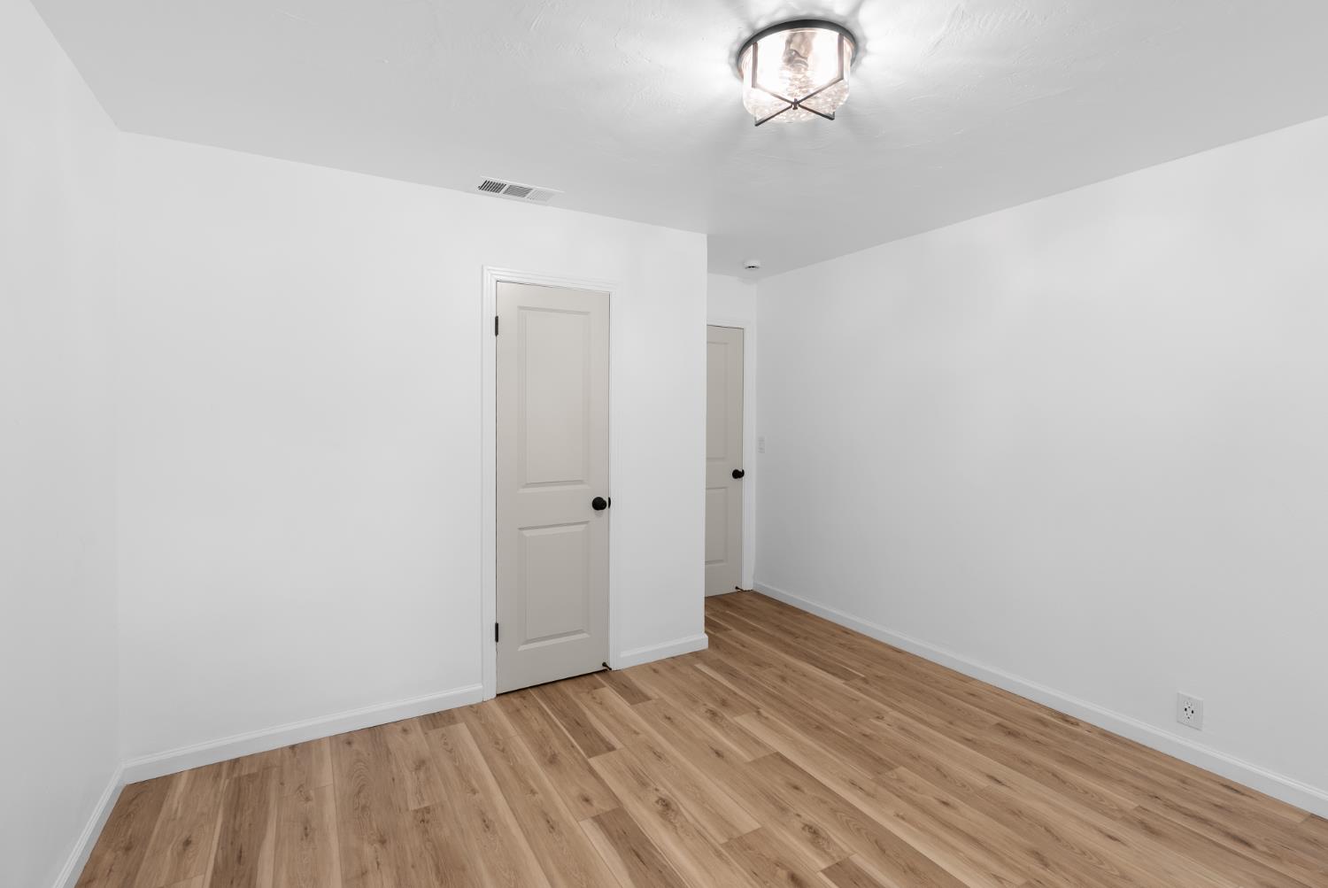 1125 Wellesley Avenue Modesto, CA 95350 - Photo 28 of 43 a view of room with wooden floor and window