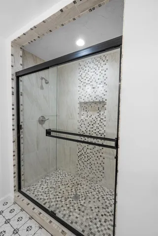 a bathroom with a shower and a sink