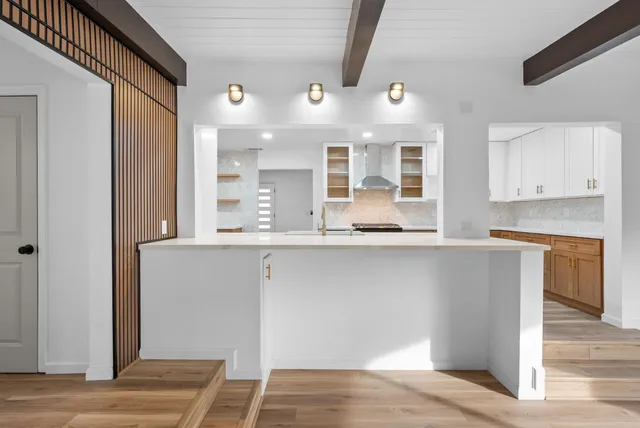 a kitchen with stainless steel appliances granite countertop a refrigerator and a sink