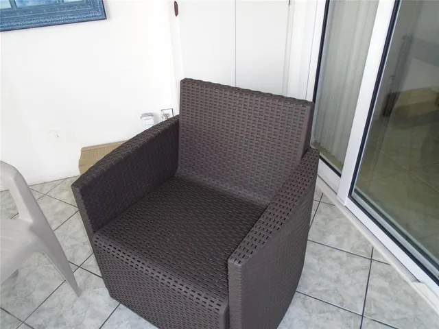 a view of balcony with furniture