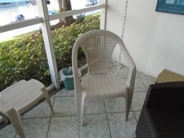 a view of a roof deck with table and chairs