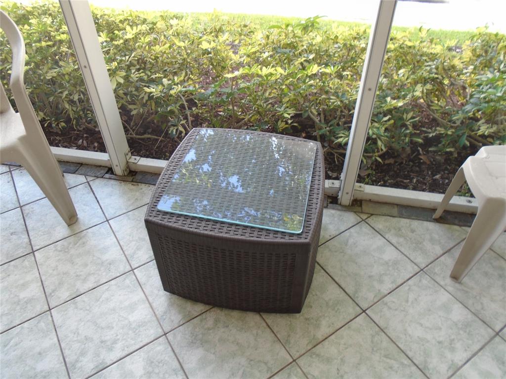 3165 Northeast 48th Court, Unit 110 Lighthouse Point, FL 33064 - Photo 13 of 49 a view of a roof deck with table and chairs