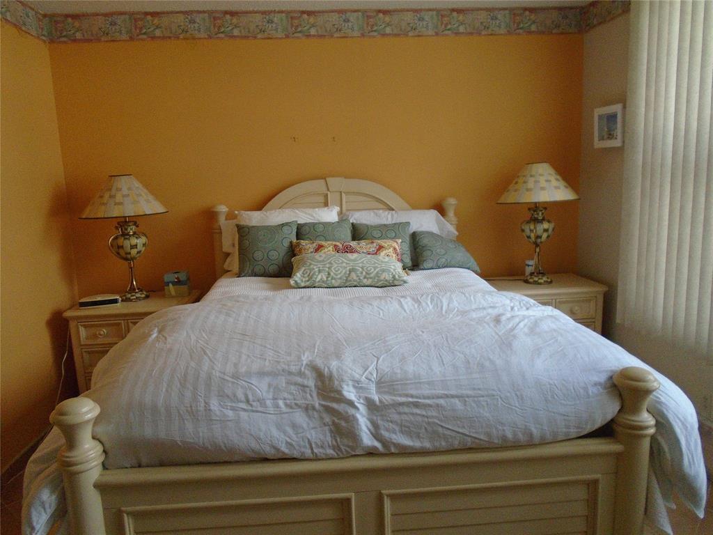 3165 Northeast 48th Court, Unit 110 Lighthouse Point, FL 33064 - Photo 15 of 49 a bedroom with a bed and teddy bear on bed