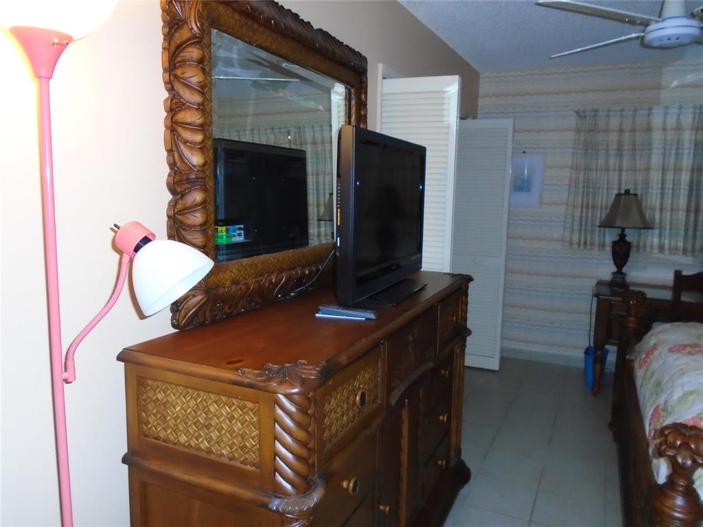 3165 Northeast 48th Court, Unit 110 Lighthouse Point, FL 33064 - Photo 21 of 49 a kitchen with a stove and a microwave