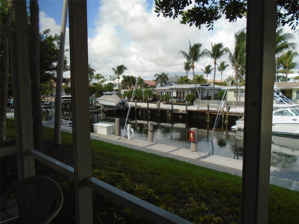 3165 Northeast 48th Court, Unit 110 Lighthouse Point, FL 33064 - Photo 27 of 49 a view of a chairs and table in patio with a garden