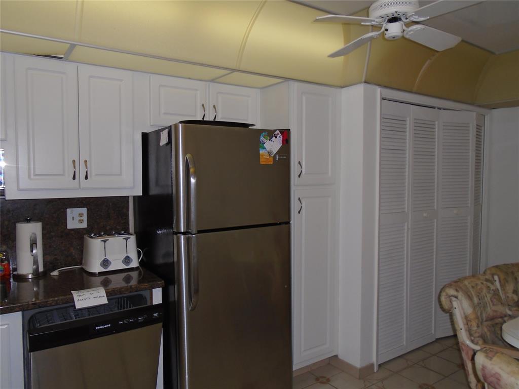 3165 Northeast 48th Court, Unit 110 Lighthouse Point, FL 33064 - Photo 30 of 49 a white refrigerator freezer sitting in a kitchen