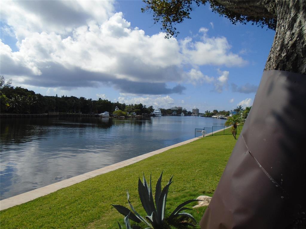 3165 Northeast 48th Court, Unit 110 Lighthouse Point, FL 33064 - Photo 39 of 49 a view of a lake with a yard