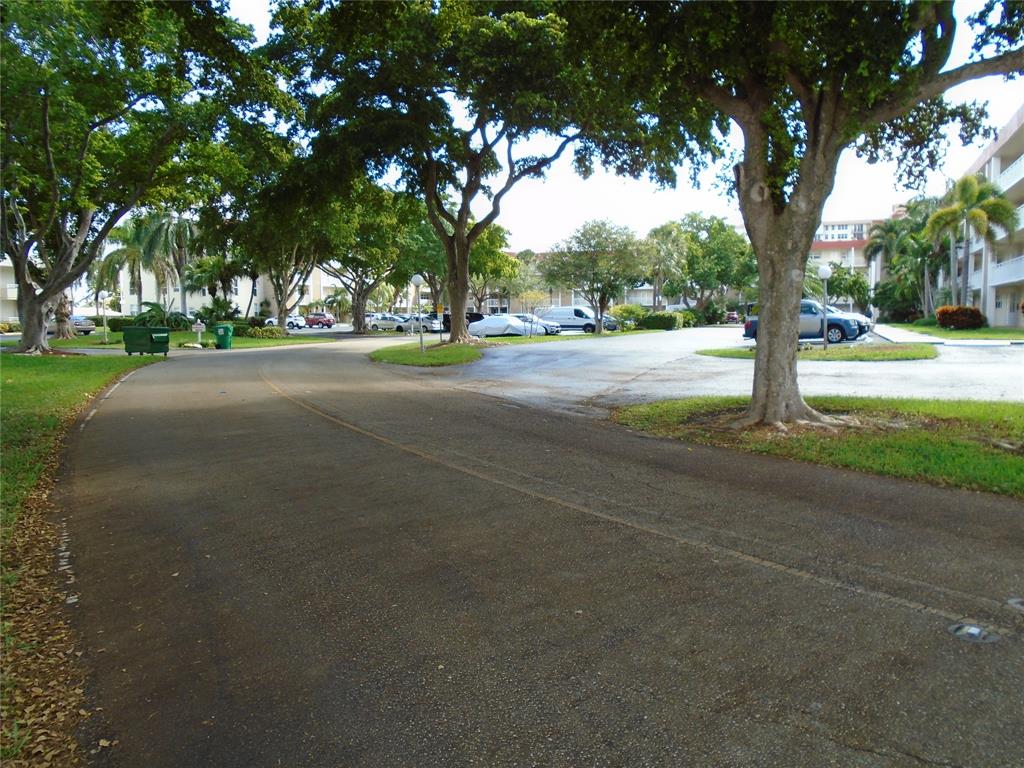 3165 Northeast 48th Court, Unit 110 Lighthouse Point, FL 33064 - Photo 44 of 49 a view of road and trees