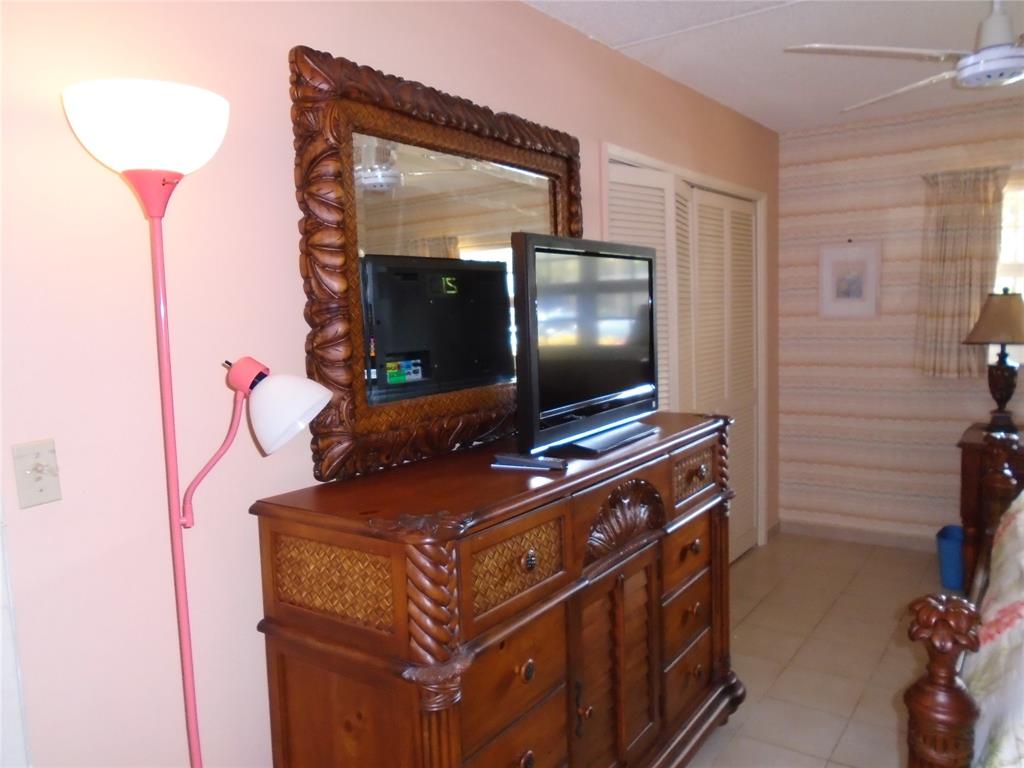 3165 Northeast 48th Court, Unit 110 Lighthouse Point, FL 33064 - Photo 47 of 49 a room with furniture and flat screen tv