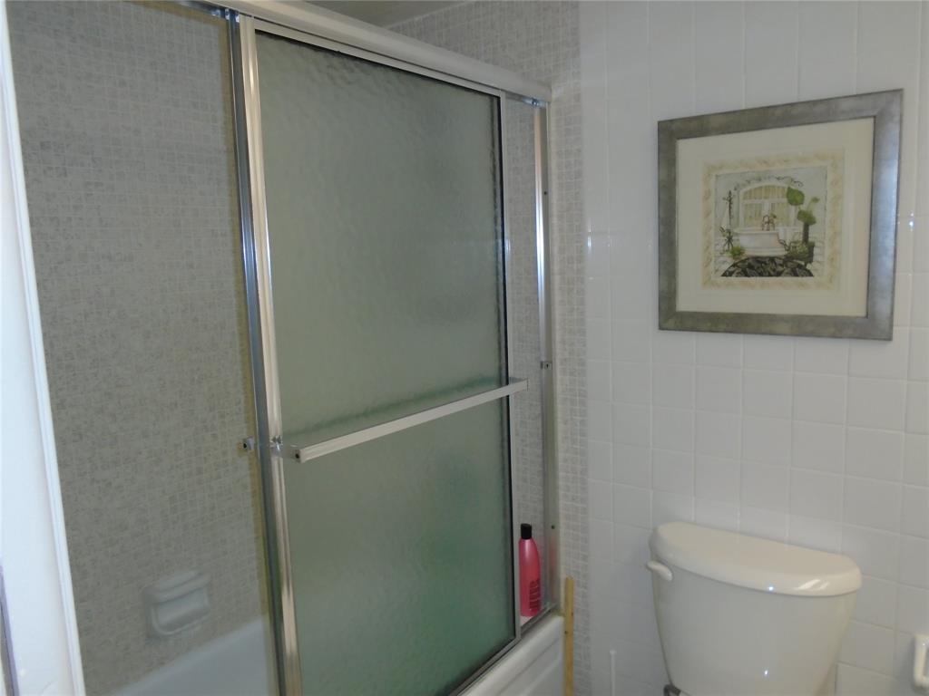 3165 Northeast 48th Court, Unit 110 Lighthouse Point, FL 33064 - Photo 48 of 49 a bathroom with a toilet and a shower