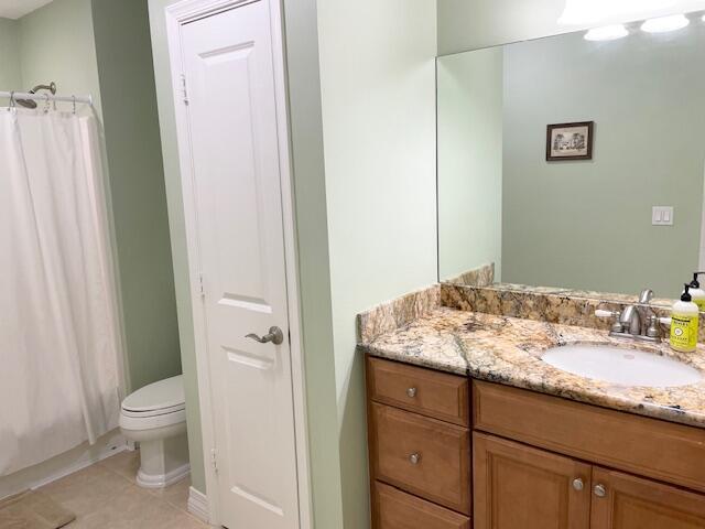 1420 Ocean Way, Unit 23C Jupiter, FL 33477 - Photo 12 of 32 a bathroom with a granite countertop sink toilet and shower