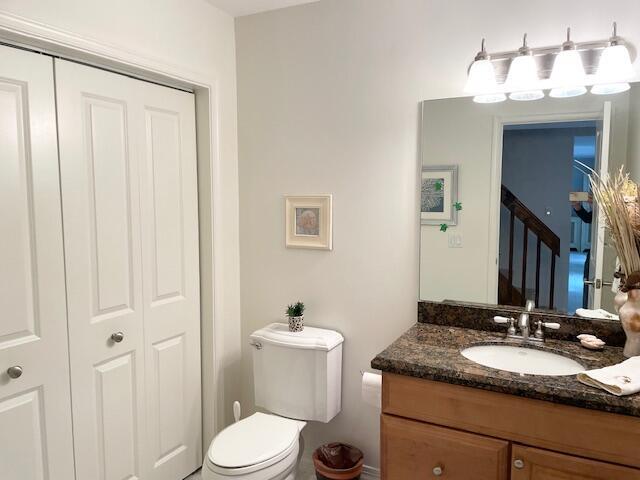 1420 Ocean Way, Unit 23C Jupiter, FL 33477 - Photo 13 of 32 a bathroom with a granite countertop sink toilet and mirror