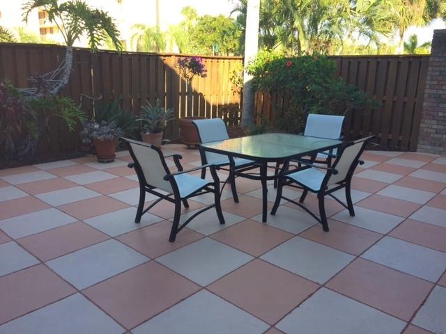1420 Ocean Way, Unit 23C Jupiter, FL 33477 - Photo 16 of 32 a view of a chairs and table in the back yard of the house