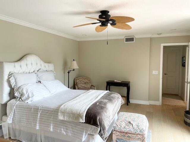 1420 Ocean Way, Unit 23C Jupiter, FL 33477 - Photo 9 of 32 a bedroom with a bed and a chandelier