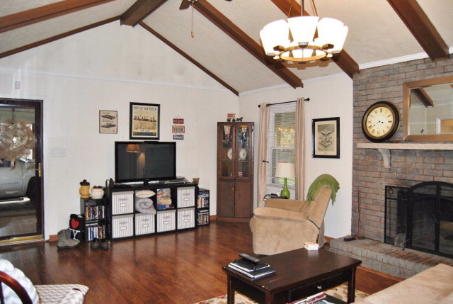 6298 Thomaston Road Macon, GA 31220 - Photo 12 of 33 a living room with furniture a flat screen tv and a fireplace